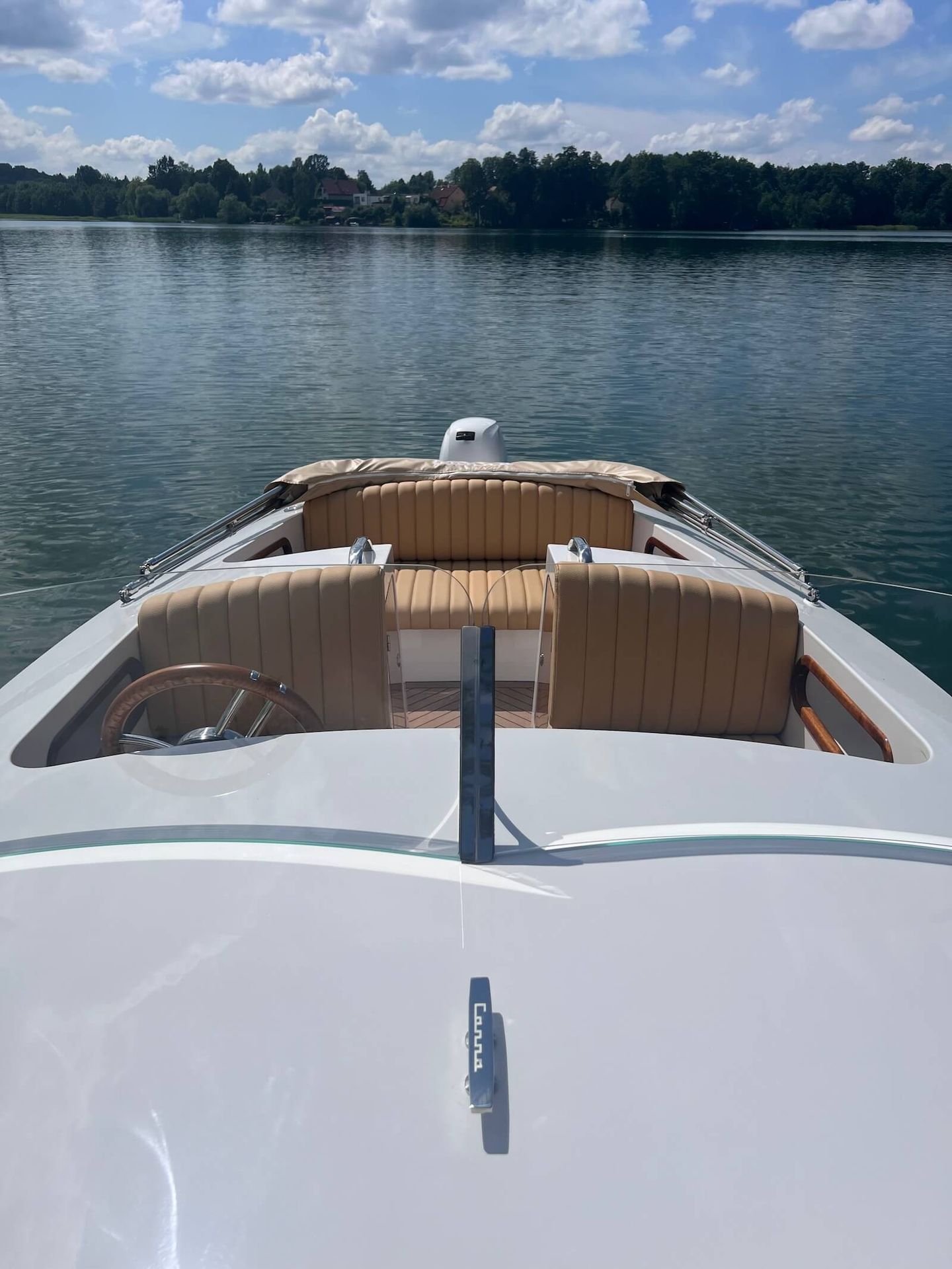white boat with combustion outboard engine CANNA b-One